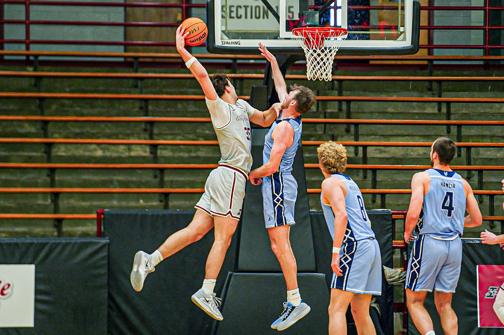 UINDY Basketball Player Dunking